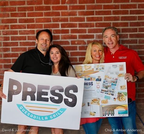 Picture of co-founders holding a sign with the Press logo.